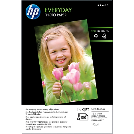 A smiling girl holding pink tulips, on a pack of HP photo paper.