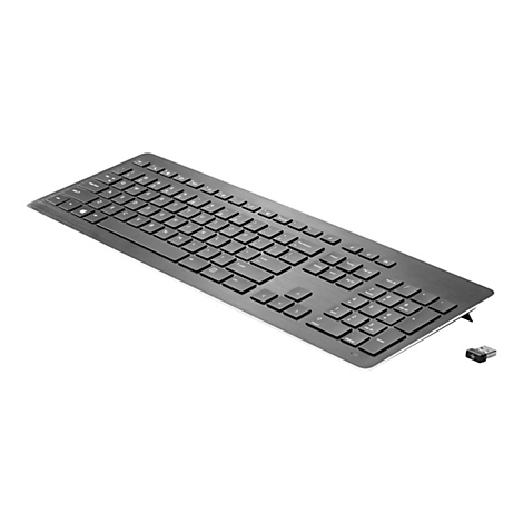 Draufsicht auf eine graue Tastatur mit schwarzer Beschriftung, daneben ein USB-Empfänger.