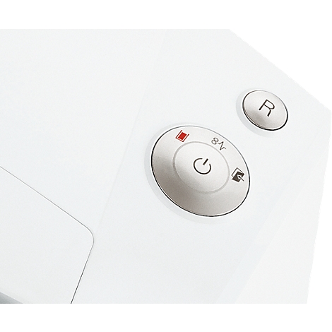 Close-up of white buttons on white background. A round button with the on/off symbol, a red light next to it, and another button with the letter 'R'.
