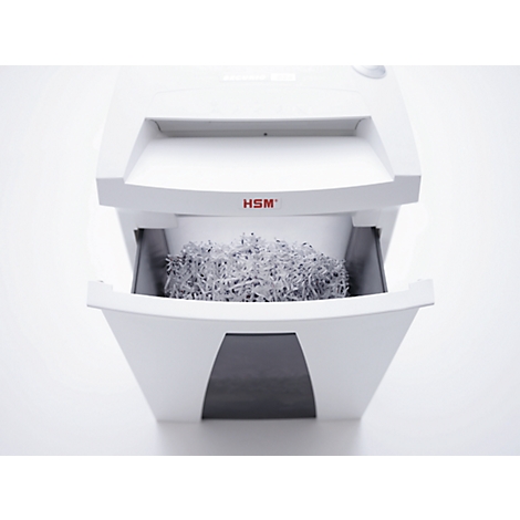 White paper shredder with open drawer filled with shredded paper. Reads "HSM".