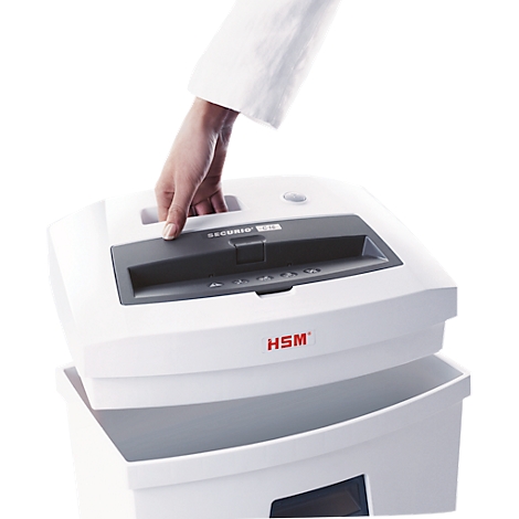 A hand lifts the white lid of a shredder. The device says HSM.