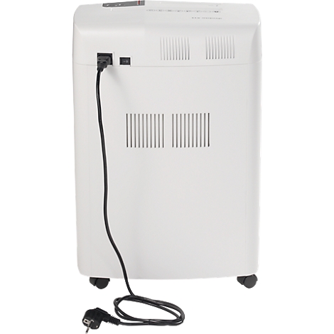 Back view of a white paper shredder. A power cable is connected. The paper shredder stands on wheels.