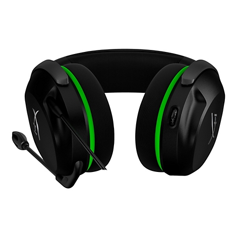 Casque de jeu noir avec des accents verts, un microphone et un logo blanc.