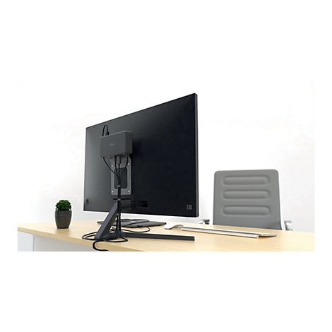 ArriÃ¨re d'un moniteur noir avec une boÃ®te montÃ©e. En dessous, un support sur la table. En arriÃ¨re-plan, une chaise de bureau.
