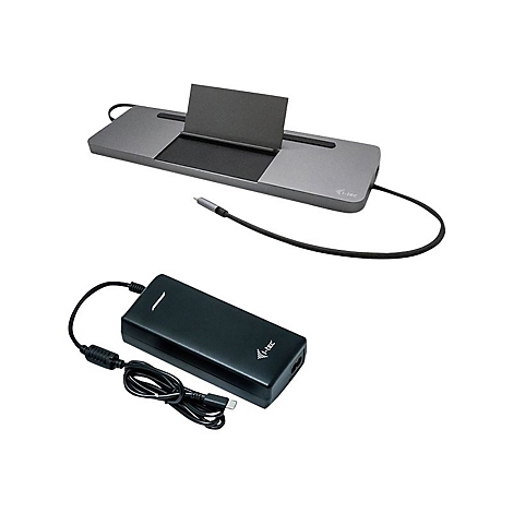 Station d'accueil grise avec insert noir, au-dessus d'un moniteur sombre. En dessous, une alimentation noire avec un cÃ¢ble USB-C.