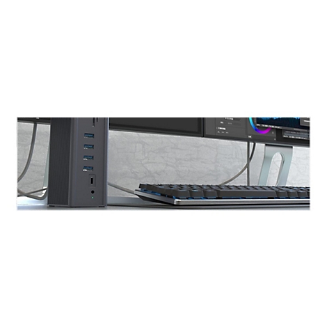 Schwarzer Dockingstation mit verschiedenen AnschlÃ¼ssen, Tastatur und Monitor im Hintergrund. Kabel sind zu sehen.