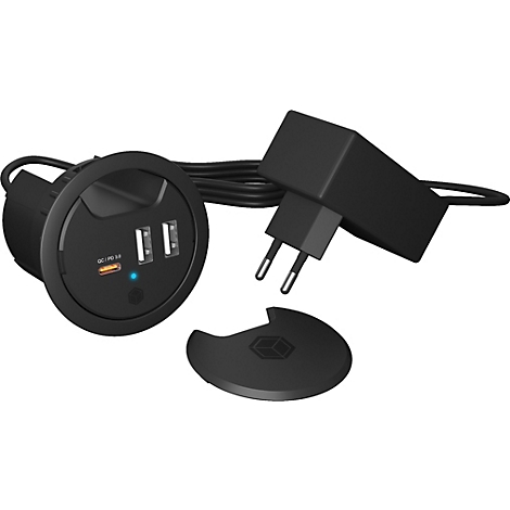 Schwarze USB-Ladestation mit zwei Ports und einem Netzteil. Der Deckel liegt daneben.