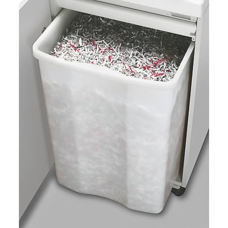 Der Abfallbehälter eines Aktenvernichters, gefüllt mit geschreddertem Papier, das teilweise rot gefärbt ist.