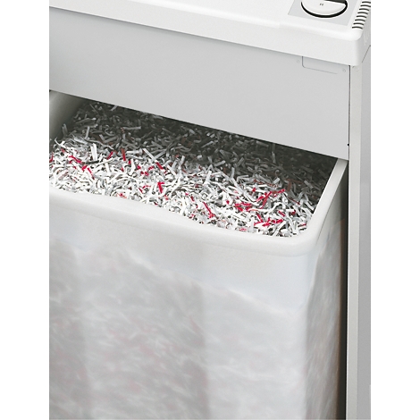 Nahaufnahme eines Aktenvernichters mit vollem Auffangbehälter, gefüllt mit geschreddertem Papier.