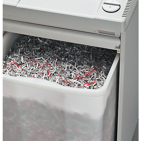 Papier-Schredder mit vollem Auffangbehälter, gefüllt mit zerrissenem Papier in Grau, Weiss und Rot.