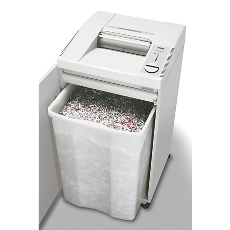 Witte papierversnipperaar. De afvalbak is gevuld met versnipperd papier.