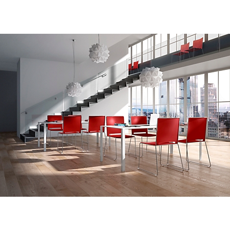 Dining room with wood floor. Red chairs and white tables are in front of a window with city view. Pendant lamps illuminate the room.