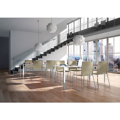 Bright room with table, chairs, and stairs. Cityscape through large windows. Ceiling lamps and parquet floor.