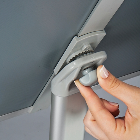 Close-up of a hand operating a grey twist closure to secure a grey panel to a metal rod.