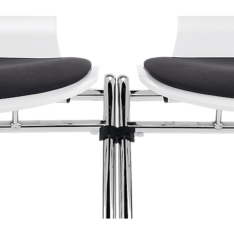 Close-up of two chairs. White seats with black cushions on a chrome frame. The detail shows the legs.