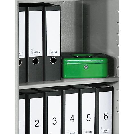 A steel cabinet with black folders and a green cassette. On the folders are white labels with the inscription FORMAT.