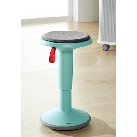 Turquoise standing aid with gray seat, red loop for adjustment. On light wooden floor.