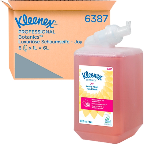 Jabón de manos en espuma rosa grande de Kleenex y una caja naranja con información del producto.