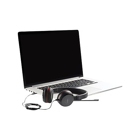 Un ordinateur portable avec un écran noir et un casque repose sur une surface blanche.