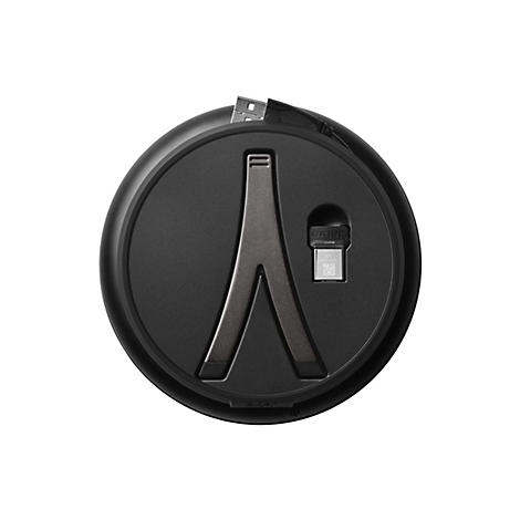 Chargeur rond gris foncé avec connecteur USB inséré et un dongle Jabra argenté. Un support en forme de V au milieu.