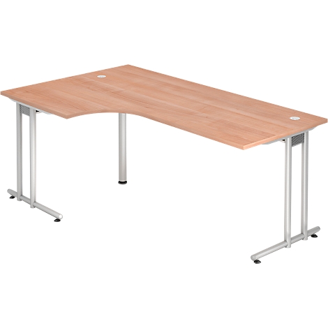 An L-shaped wooden desk, secured by silver legs. There are two circular openings on the table top.