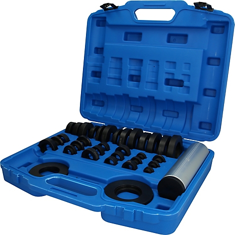 Une mallette en plastique bleu contenant des bagues de montage noires assorties et un cylindre outil argenté.