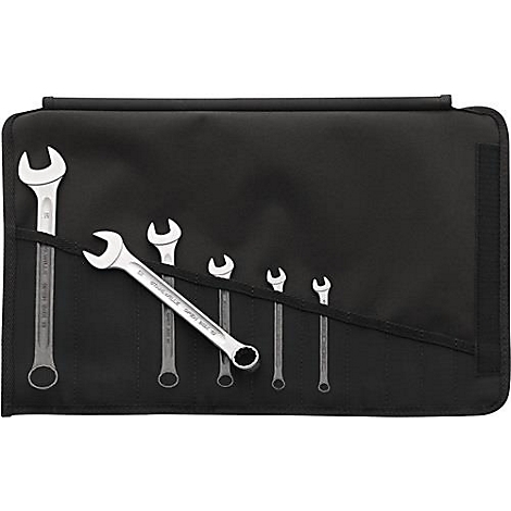 Un rouleau d'outils avec diverses clés, dépassant partiellement de la pochette noire.