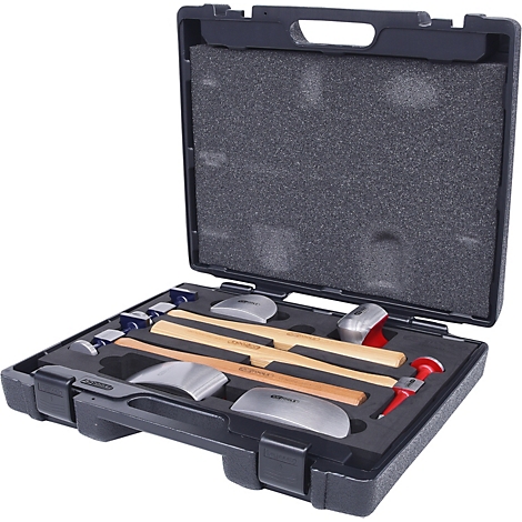Werkzeugset in schwarzem Koffer: Hämmer, Stempel und Formen. Koffer offen, Werkzeuge angeordnet.