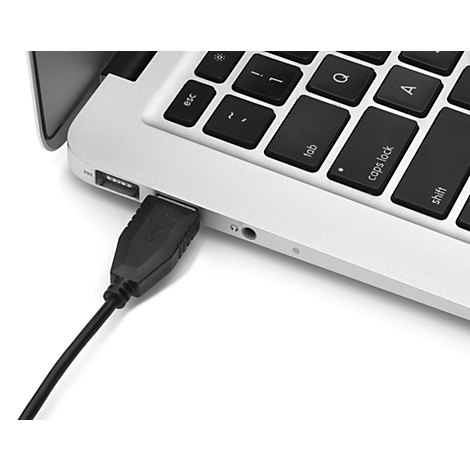 Close-up of a laptop connected to a black USB cable. The cable is plugged into the USB port.