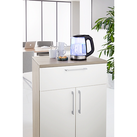 A kettle with blue lighting sits on a cabinet, next to cups and pastries.