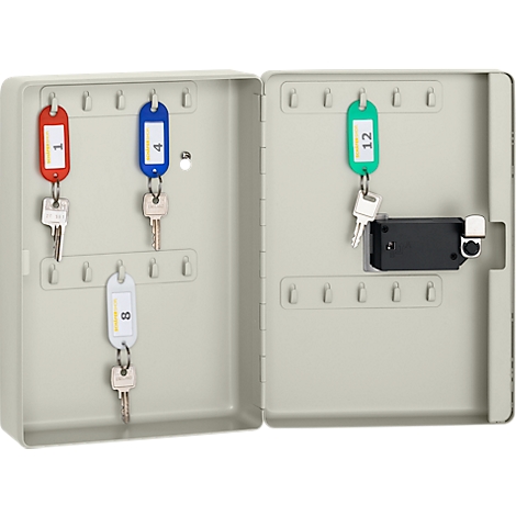 Opened key cabinet with keys. The key fobs are color-coded and numbered. A lock is also present.