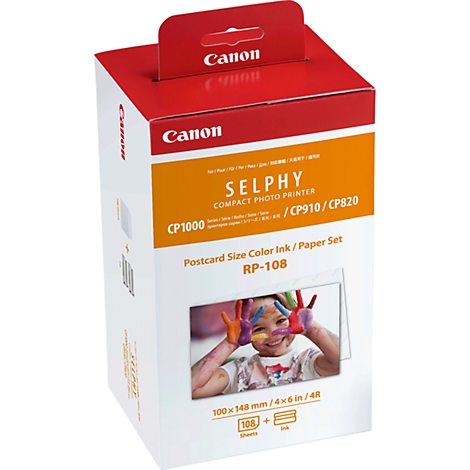 Boîte de cartouches d'imprimante photo Canon Selphy. Impression avec un enfant heureux qui peint les mains.