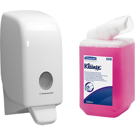 White soap dispenser and a pink soap bottle with Kleenex logo.