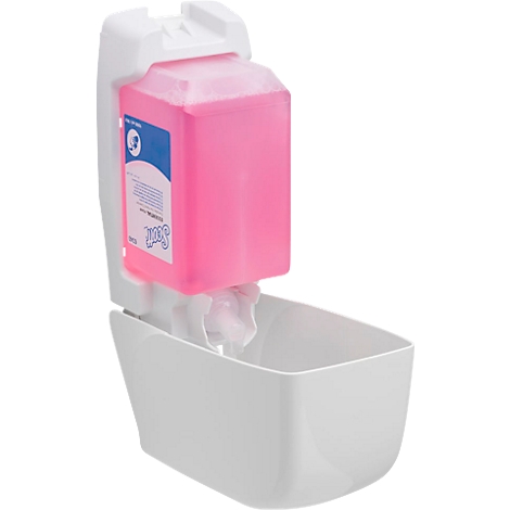 Dispensador de jabón blanco con jabón líquido rosa y recipiente colector. Etiqueta con texto.