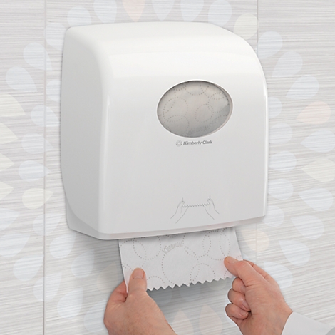 Weisser Papierhandtuchspender mit ovalem Sichtfenster, Hände ziehen Papiertuch heraus.