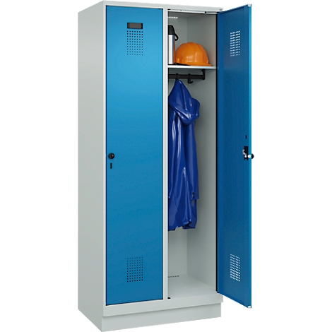 Ein Spind mit blau lackierten Türen steht offen. Im Inneren: Helm, Jacke und Flasche.