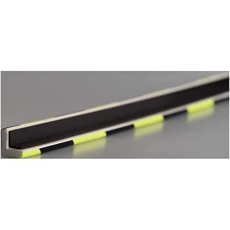 Close-up of an L-shaped bar with yellow markings. It lies on a gray background.