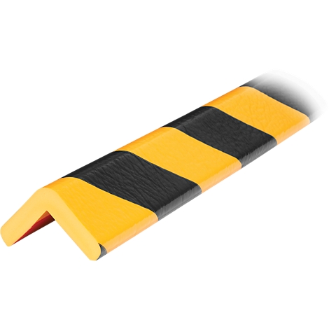 Un protector de esquina amarillo y negro en forma de L flotando frente a una superficie blanca.