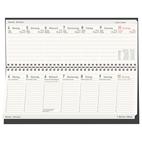 Un calendrier ouvert avec les dates de la semaine de janvier et une reliure à spirale.