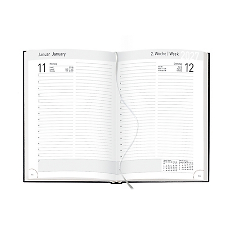 Carnet ouvert avec des pages pour les notes. Le carnet a des couvertures noires et un signet en ruban. La page de gauche indique "11 janvier", la page de droite "12".