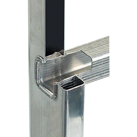 Detailed close-up of a metallic, angular construction connecting two tubes. Sharp edges and precise cutouts.