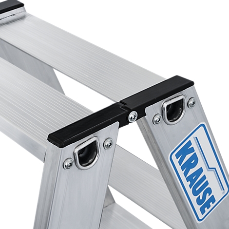 Detailaufnahme einer silbernen Aluminium-Trittleiter. Schwarze Kunststoffabdeckungen an den Sprossen, das blaue Krause-Logo ist sichtbar.