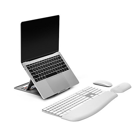 Laptop on stand, keyboard, mouse and wrist rest. White background.