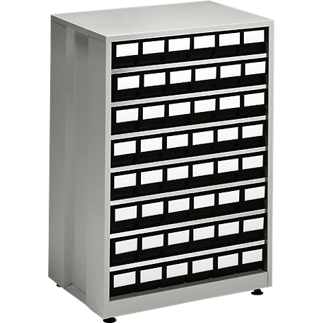 Grey cabinet with many drawers with black frames and white labels. Standing on dark floor.