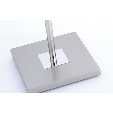 Close-up of a metal stand base plate with an embedded pole.