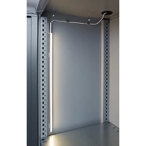 Inside view of a cabinet with LED light. Gray metal walls and frames. A white cable leads to the ceiling.