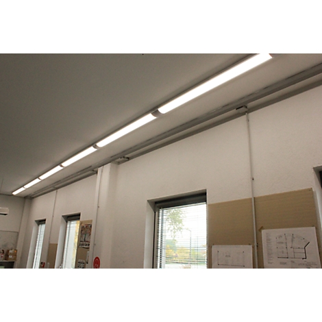 Ceiling lights in a bright room, with windows and drawings.