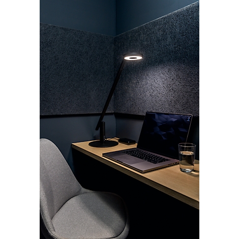 Desk with lamp, laptop, glass of water and chair. Dark background.