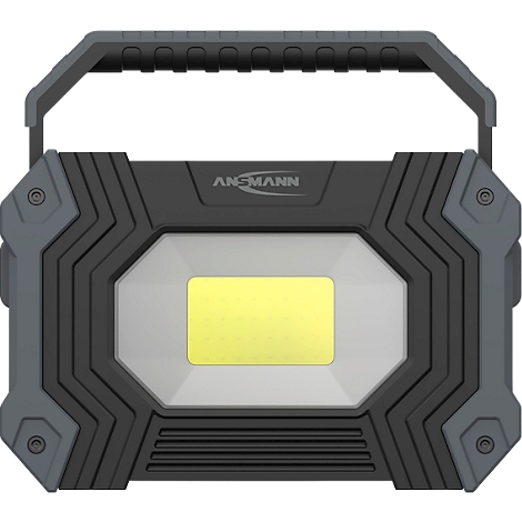Black and gray LED work light with carrying handle and yellow light field; inscription: ANSMANN.