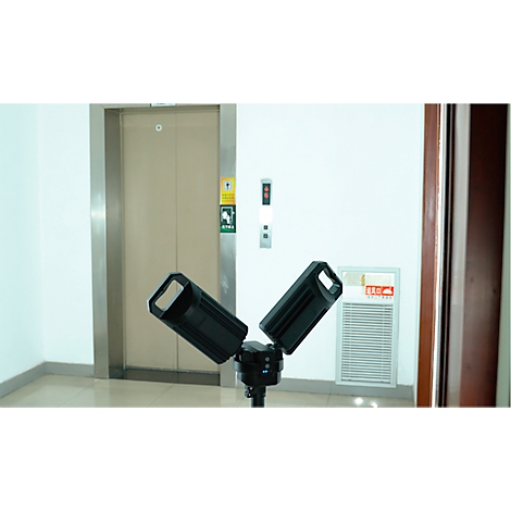 Elevator doors next to control panel and ventilation grille. Two spotlights are placed in the foreground.